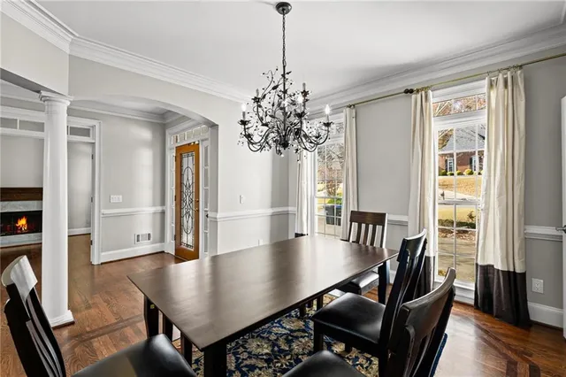 a living room with a fireplace and wooden floor