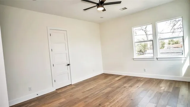 wooden floor in an empty room with a window