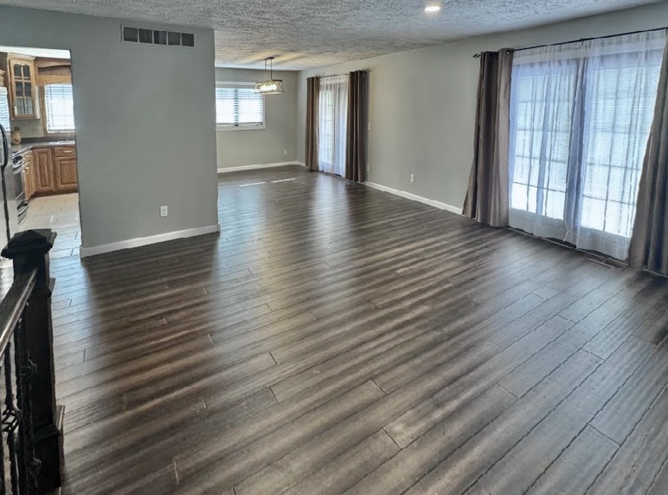 117 Colchester Drive Normal, IL 61761 - Photo 11 of 32 a view of an empty room with wooden floor and a window