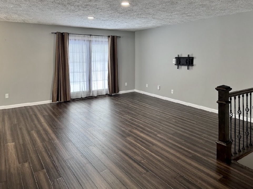 117 Colchester Drive Normal, IL 61761 - Photo 12 of 32 a view of an empty room with wooden floor and a window