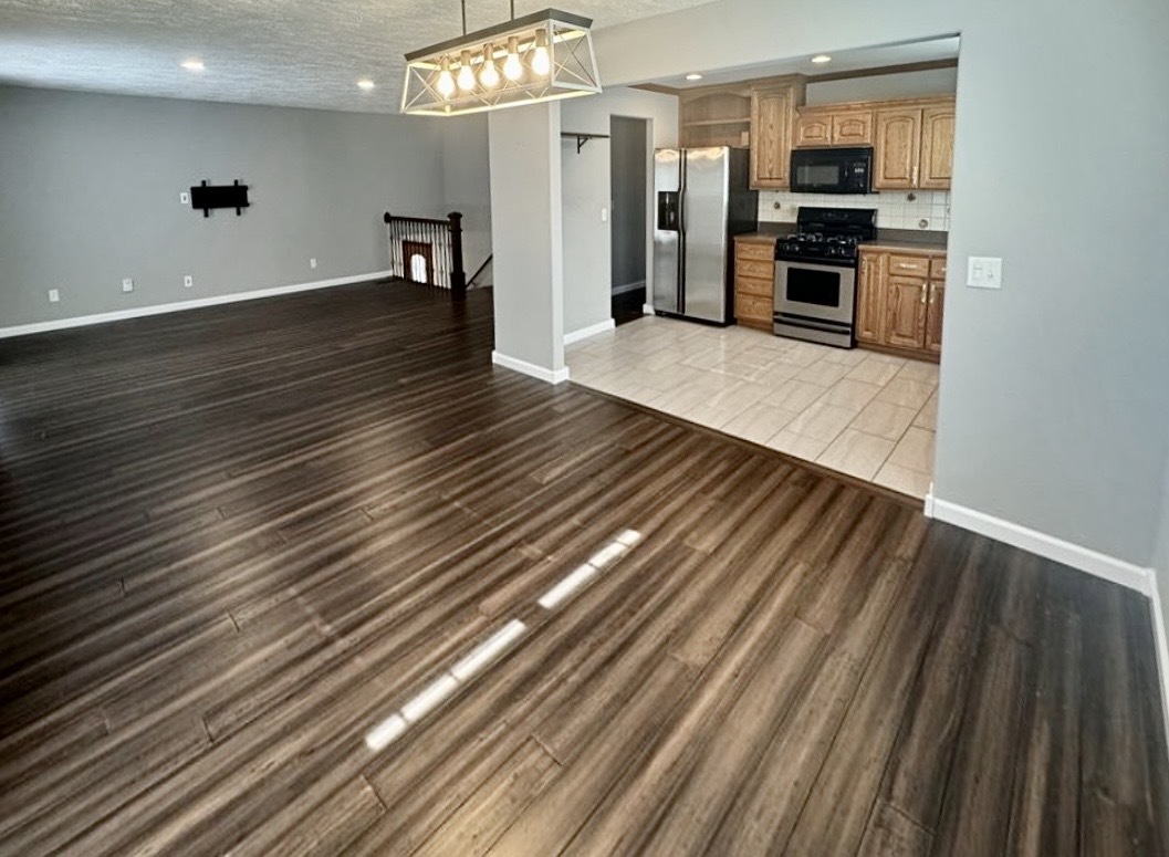 117 Colchester Drive Normal, IL 61761 - Photo 13 of 32 a kitchen with stainless steel appliances a refrigerator and wooden floor