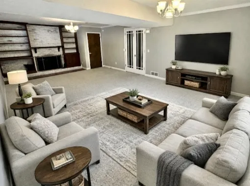 a living room with furniture a flat screen tv and a large window