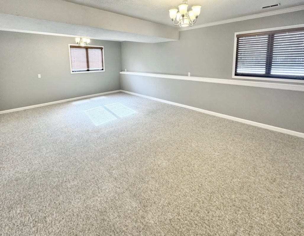 117 Colchester Drive Normal, IL 61761 - Photo 17 of 32 an empty room with windows and chandelier fan