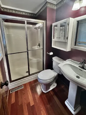 a white toilet sitting next to a bathroom sink