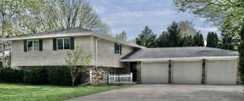 117 Colchester Drive Normal, IL 61761 - Photo 3 of 32 a front view of a house with a garden and trees