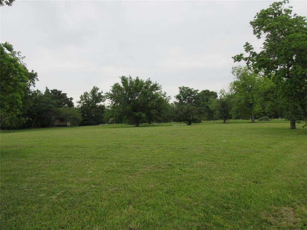 a view of outdoor space with field and trees