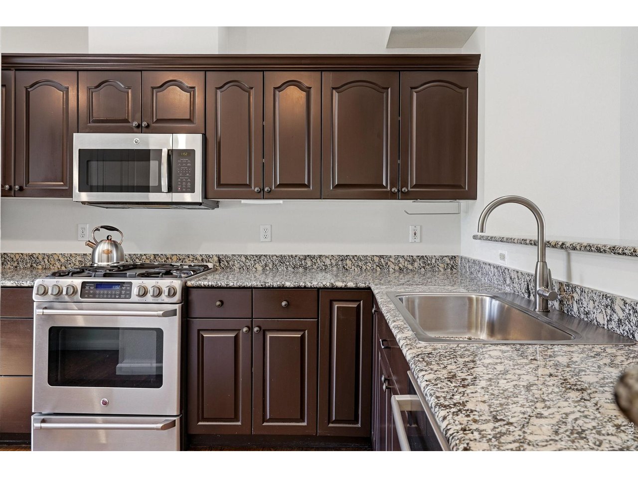 944 Ivanhoe Street Denver, CO 80220 - Photo 16 of 47 a kitchen with a stove and a microwave