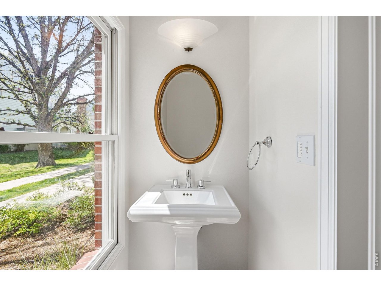 944 Ivanhoe Street Denver, CO 80220 - Photo 19 of 47 a bathroom with a sink a mirror and a shower