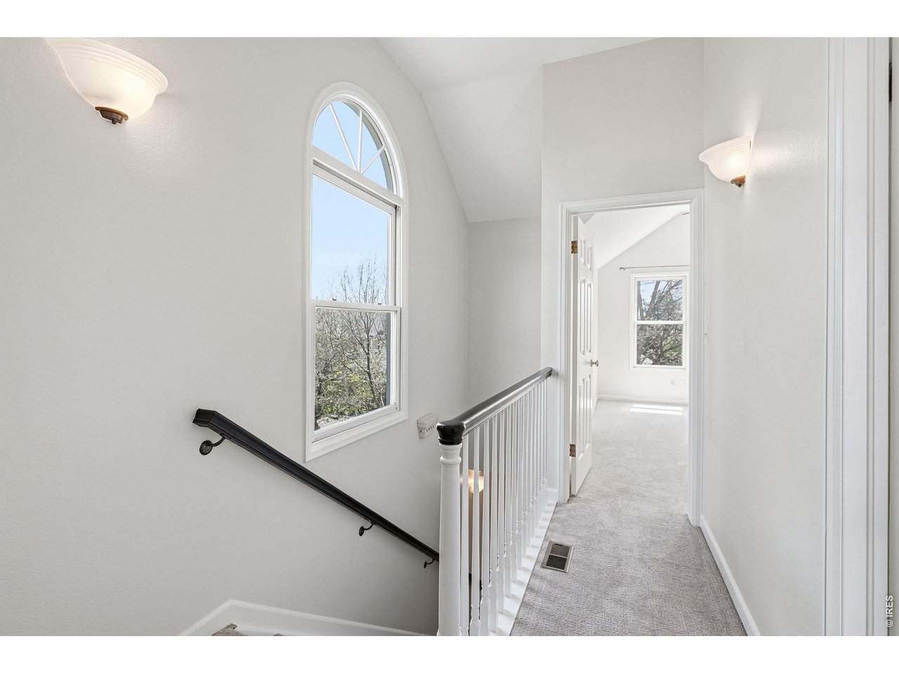 944 Ivanhoe Street Denver, CO 80220 - Photo 20 of 47 a view of a hallway with wooden floor and staircase