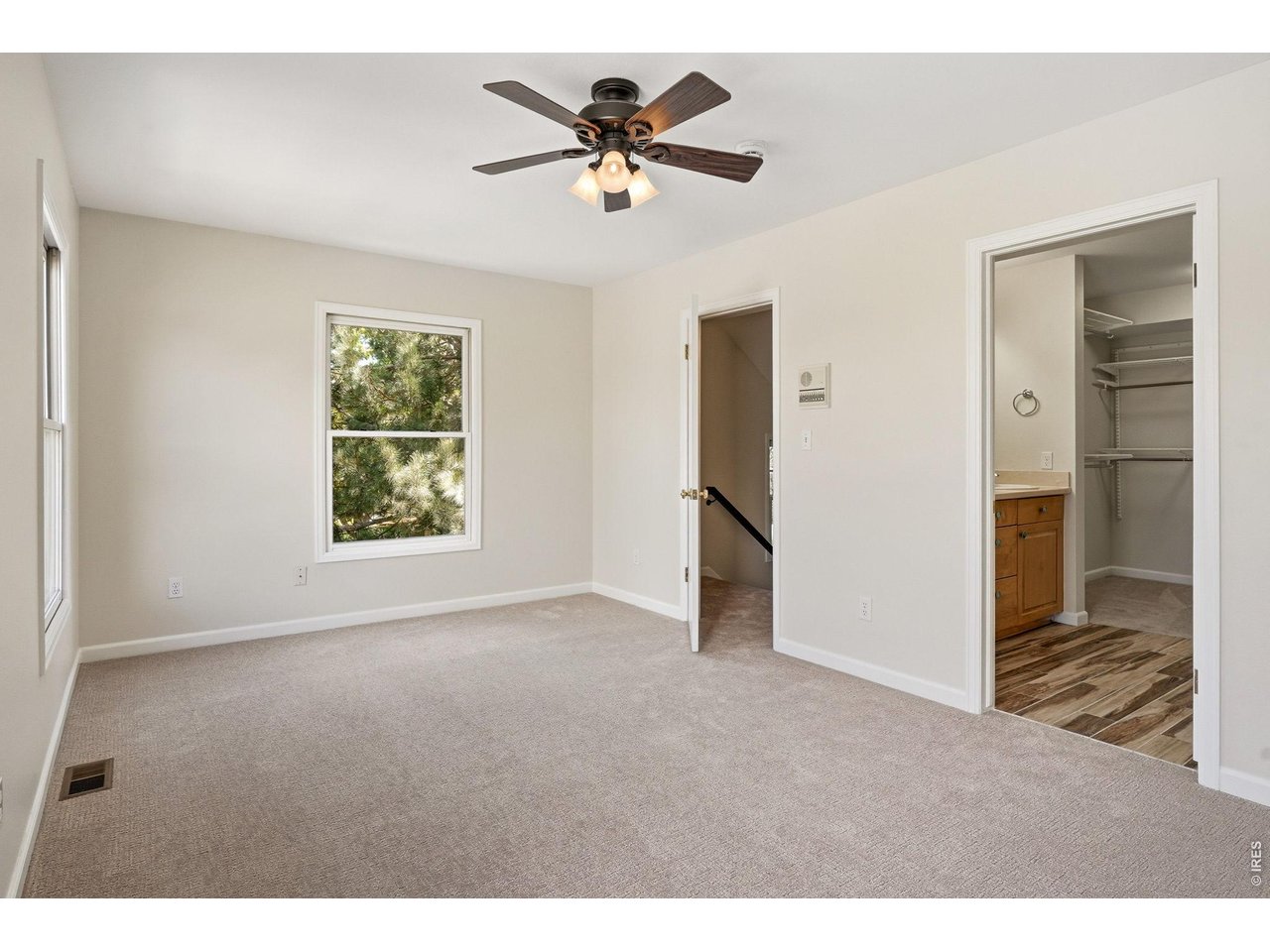 944 Ivanhoe Street Denver, CO 80220 - Photo 22 of 47 a view of an empty room with a ceiling fan