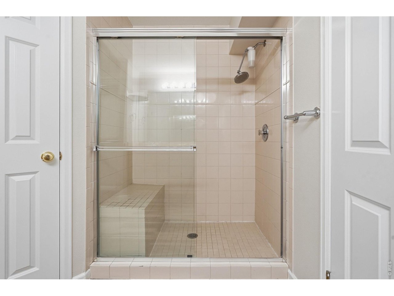 944 Ivanhoe Street Denver, CO 80220 - Photo 25 of 47 a bathroom with a glass shower door
