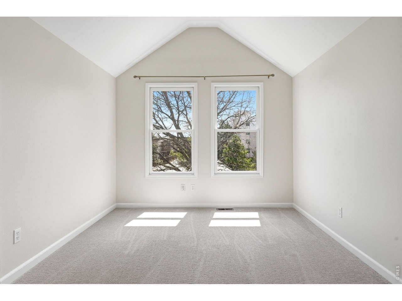 944 Ivanhoe Street Denver, CO 80220 - Photo 34 of 47 an empty room with wooden floor and windows