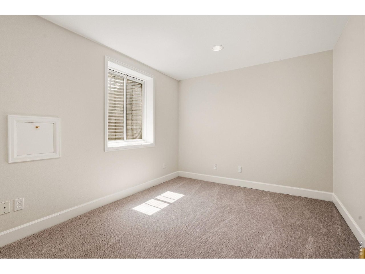 944 Ivanhoe Street Denver, CO 80220 - Photo 41 of 47 an empty room with wooden floor and windows