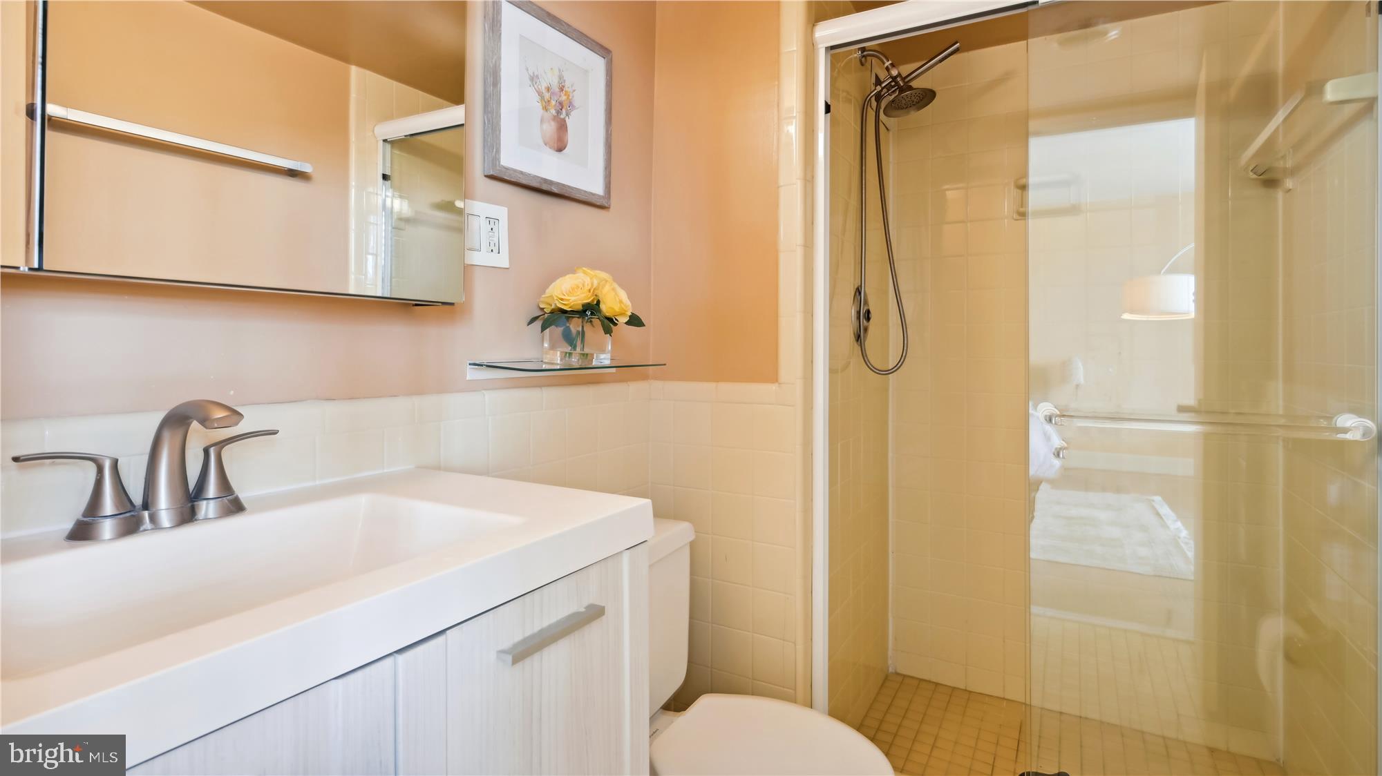 5101 River Road, Unit 602 Bethesda, MD 20816 - Photo 13 of 35 a bathroom with a sink toilet and shower