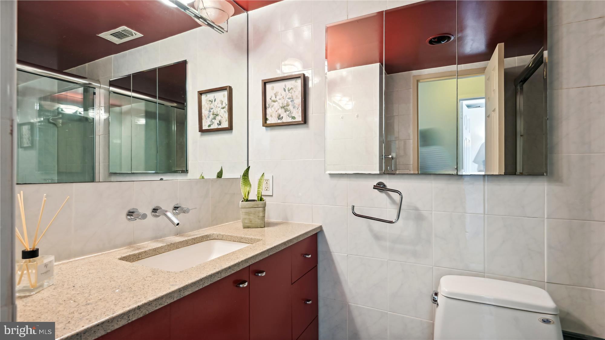 5101 River Road, Unit 602 Bethesda, MD 20816 - Photo 16 of 35 a bathroom with a granite countertop sink a toilet and shower