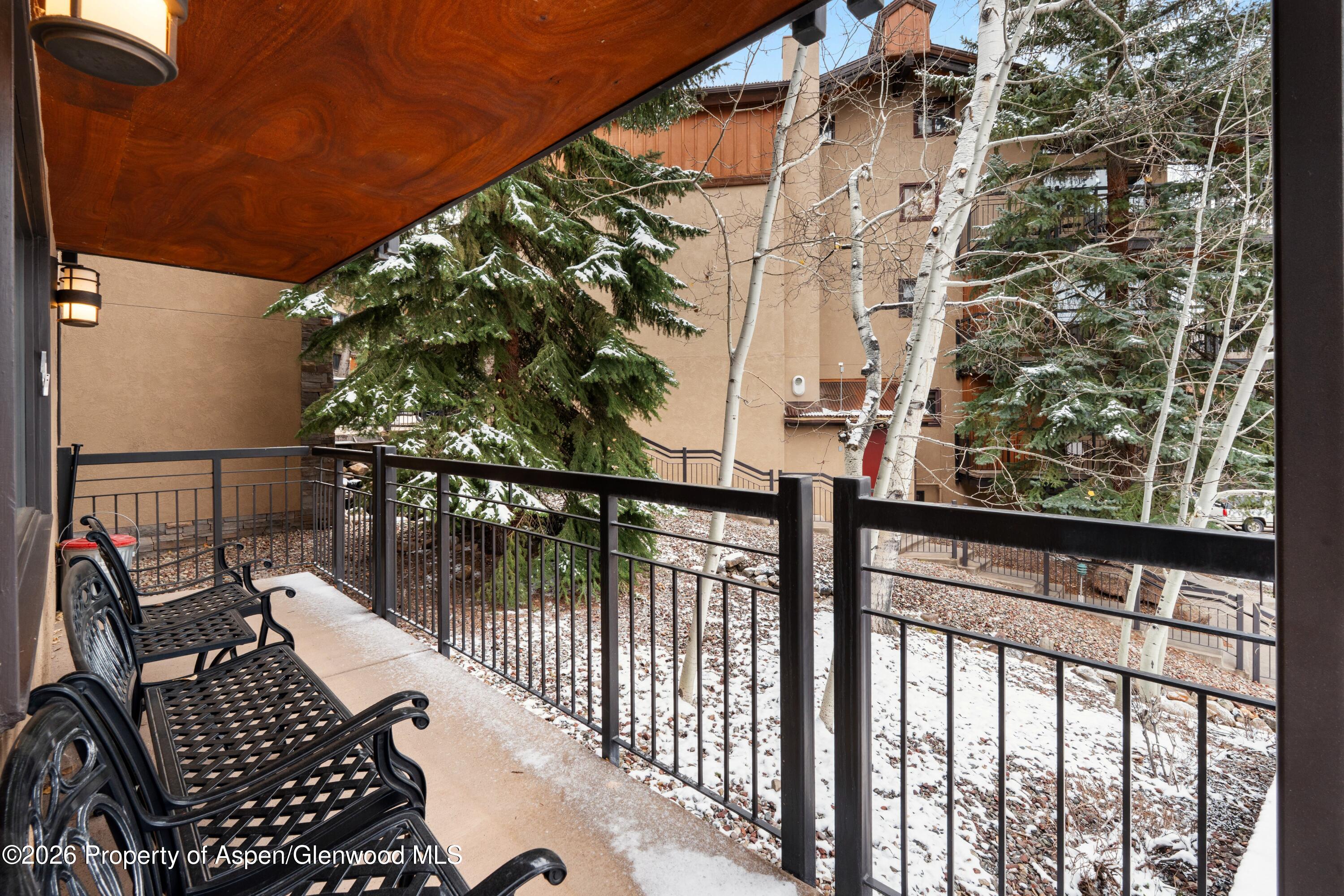 400 Wood Road, Unit 2111H Snowmass Village, CO 81615 - Photo 13 of 16 a view of balcony with wooden floor and fence