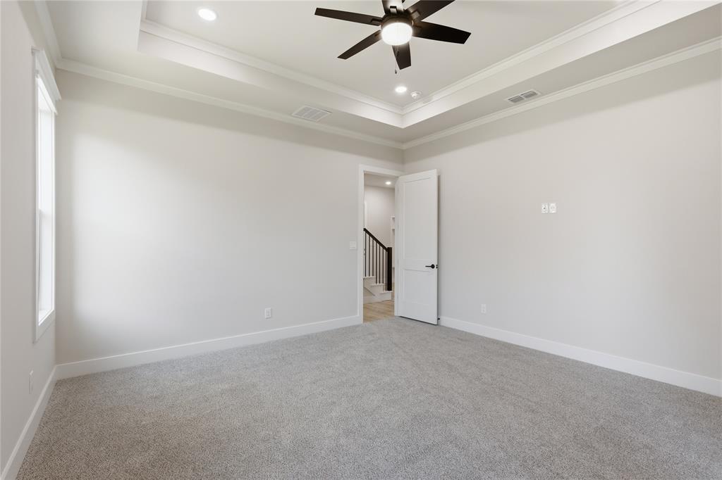 713 Anne Road Van Alstyne, TX 75495 - Photo 10 of 29 Carpeted room featuring a tray ceiling with recessed lighting and a ceiling fan, white baseboards, and a window for natural light