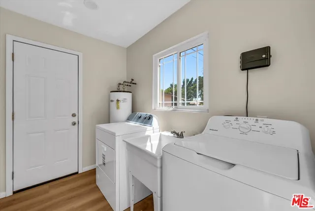 a backyard of a house with large trees and barbeque oven