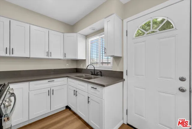 a kitchen with a sink and cabinets