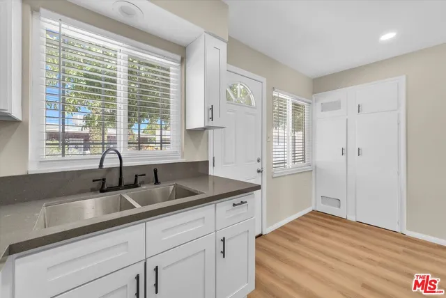 a kitchen with a sink and cabinets