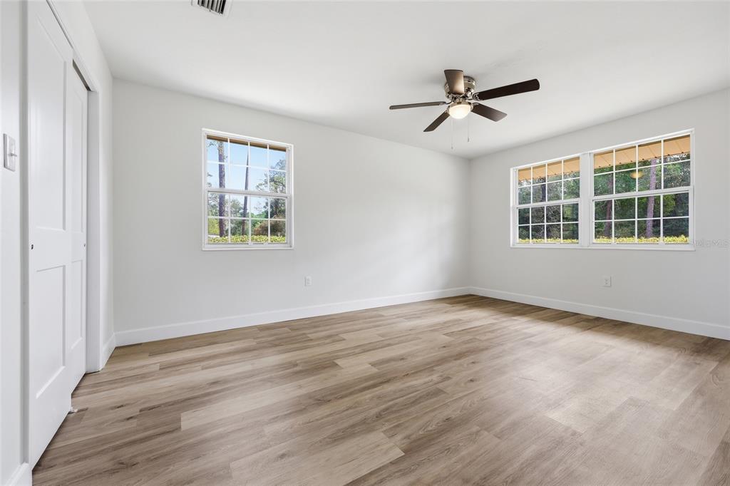 129 Southwest Benz Way Lake City, FL 32024 - Photo 12 of 30 a view of empty room with wooden floor and fan