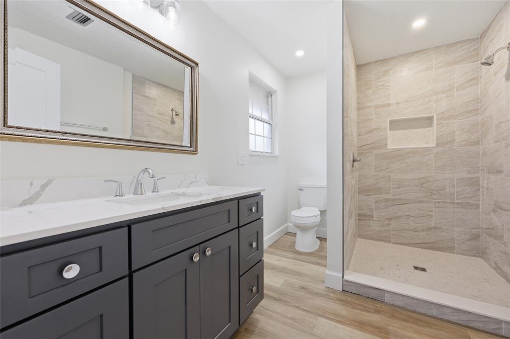 129 Southwest Benz Way Lake City, FL 32024 - Photo 14 of 30 a bathroom with a sink a toilet and shower