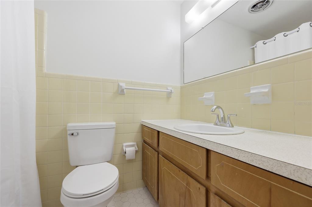 129 Southwest Benz Way Lake City, FL 32024 - Photo 17 of 30 a bathroom with a granite countertop toilet sink and mirror