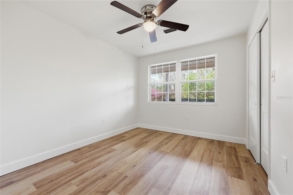 129 Southwest Benz Way Lake City, FL 32024 - Photo 18 of 30 wooden floor in an empty room with a window