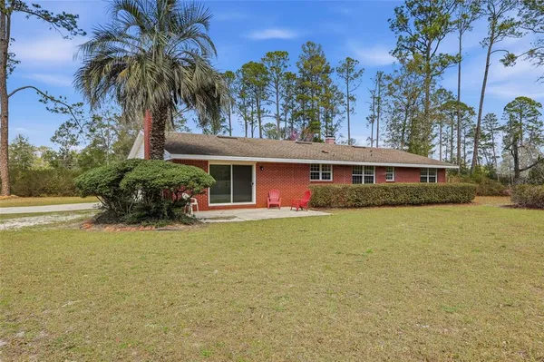 an aerial view of a house with yard