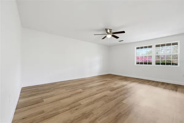 a view of a room with wooden floor