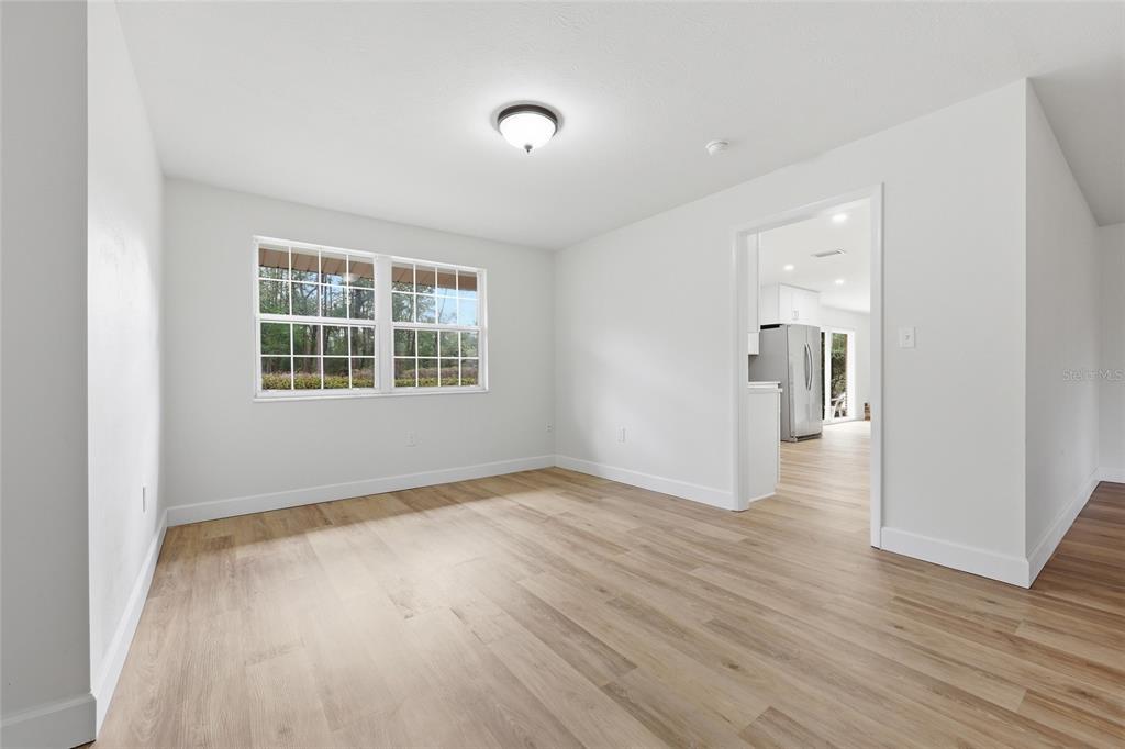 129 Southwest Benz Way Lake City, FL 32024 - Photo 7 of 30 wooden floor in an empty room with a window