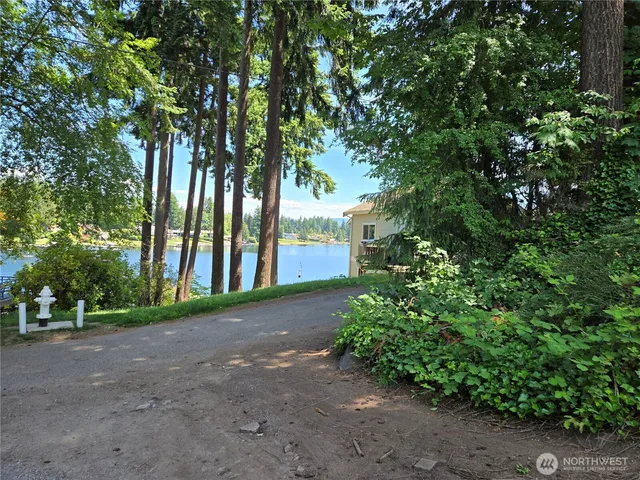 a view of a street with a building and trees in the background