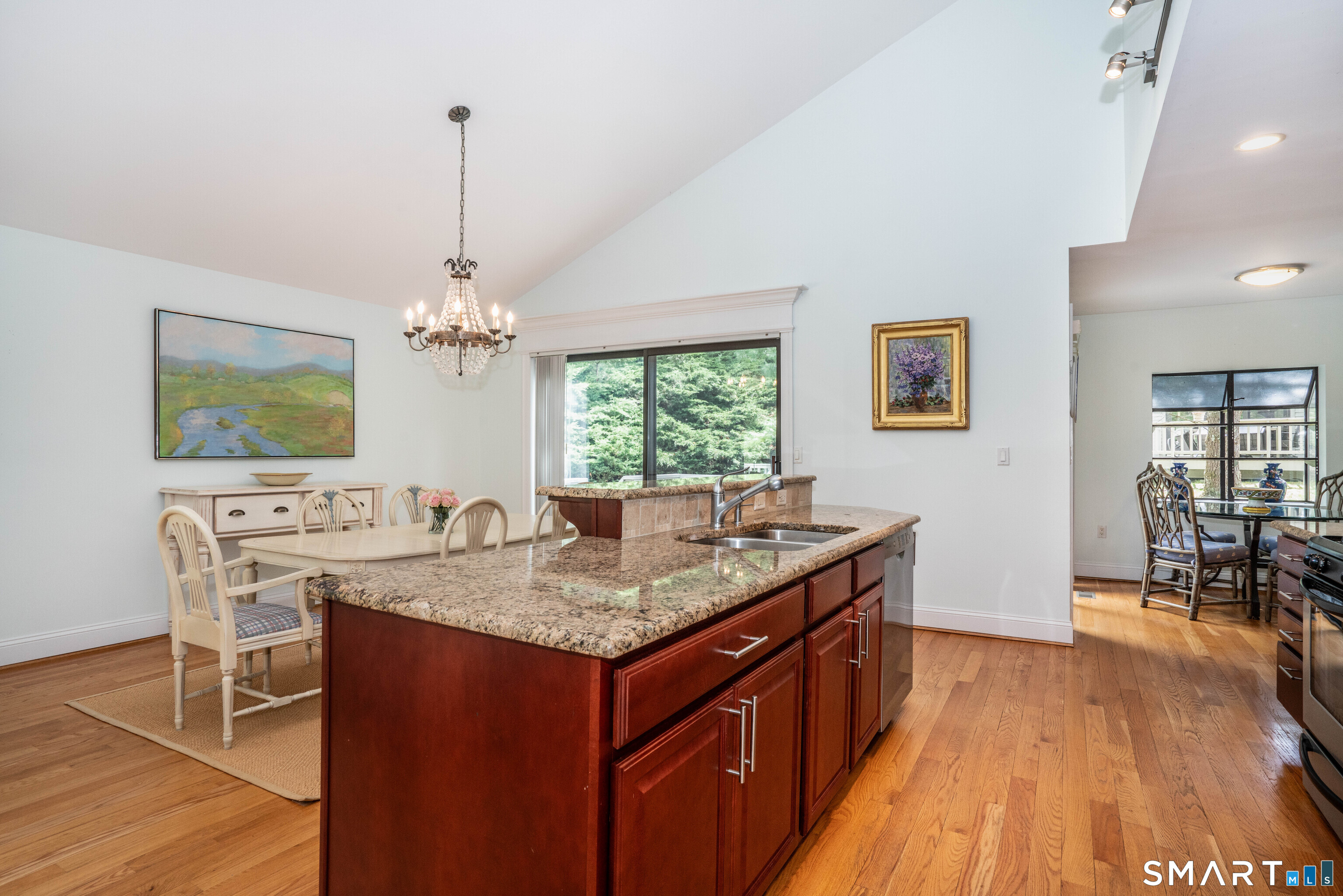 3 Morgan Place, Unit 3 Avon, CT 06001 - Photo 9 of 29 a kitchen with a counter space dining table wooden floor and a chandelier