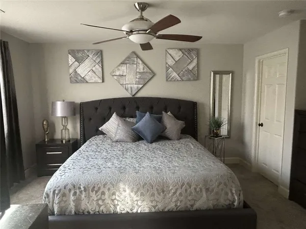 a large bed sitting in a bedroom and chandelier