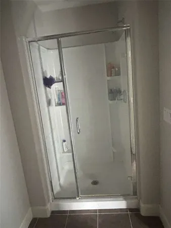 a bathroom with a glass door shower