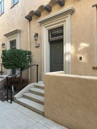 a view of a house with a door and wooden bench