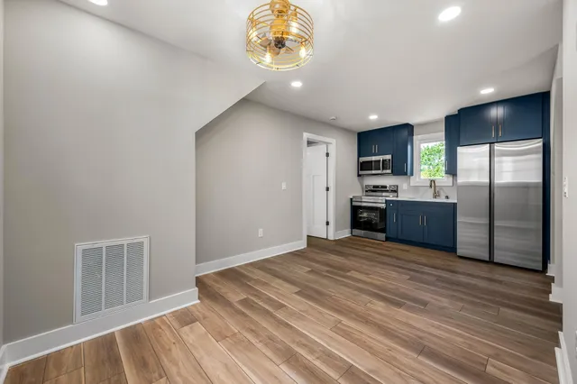 a view of a kitchen with a sink and a refrigerator