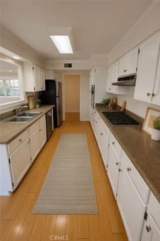 a large kitchen with white cabinets