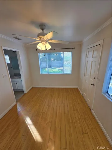 a bedroom with bed and wooden floor