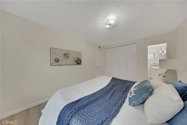 a bedroom with a bed and a lamp