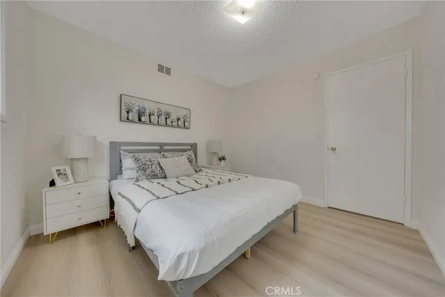 a bedroom with a bed and a night stand