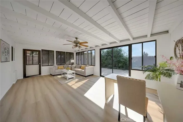 a living room with furniture and large windows