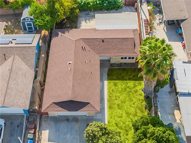 an aerial view of a house with garden space and a yard