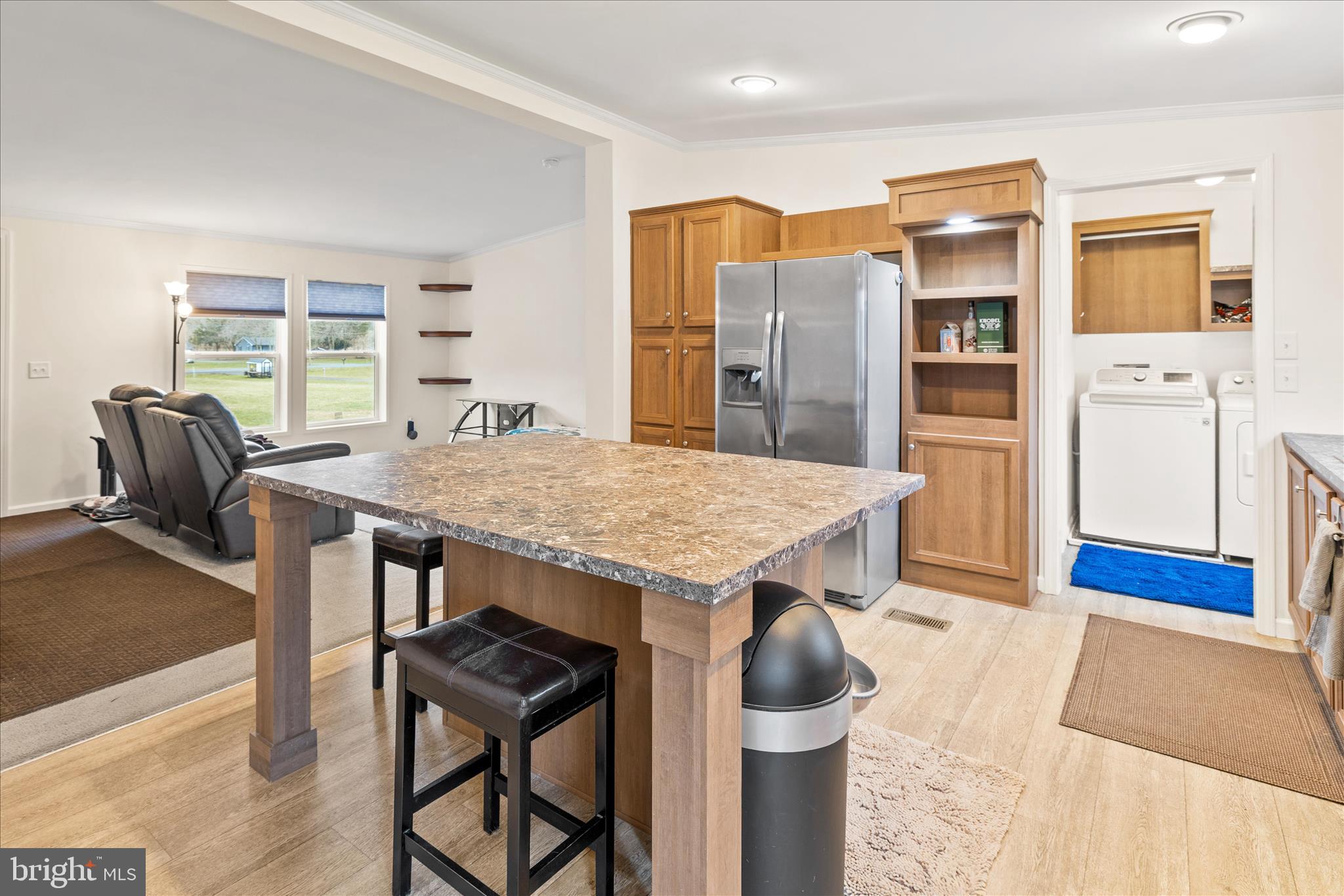 679 Oak Hill School Road Townsend, DE 19734 - Photo 11 of 50 a kitchen with stainless steel appliances kitchen island granite countertop a stove a refrigerator a dining table and chairs with wooden floor