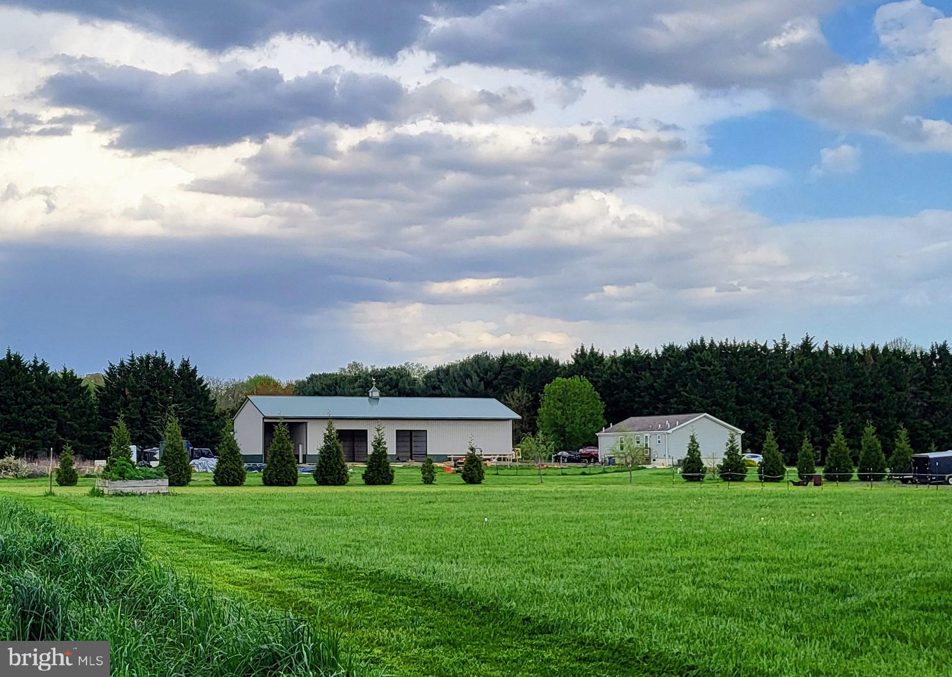 679 Oak Hill School Road Townsend, DE 19734 - Photo 44 of 50 a front view of a house with a yard and trees