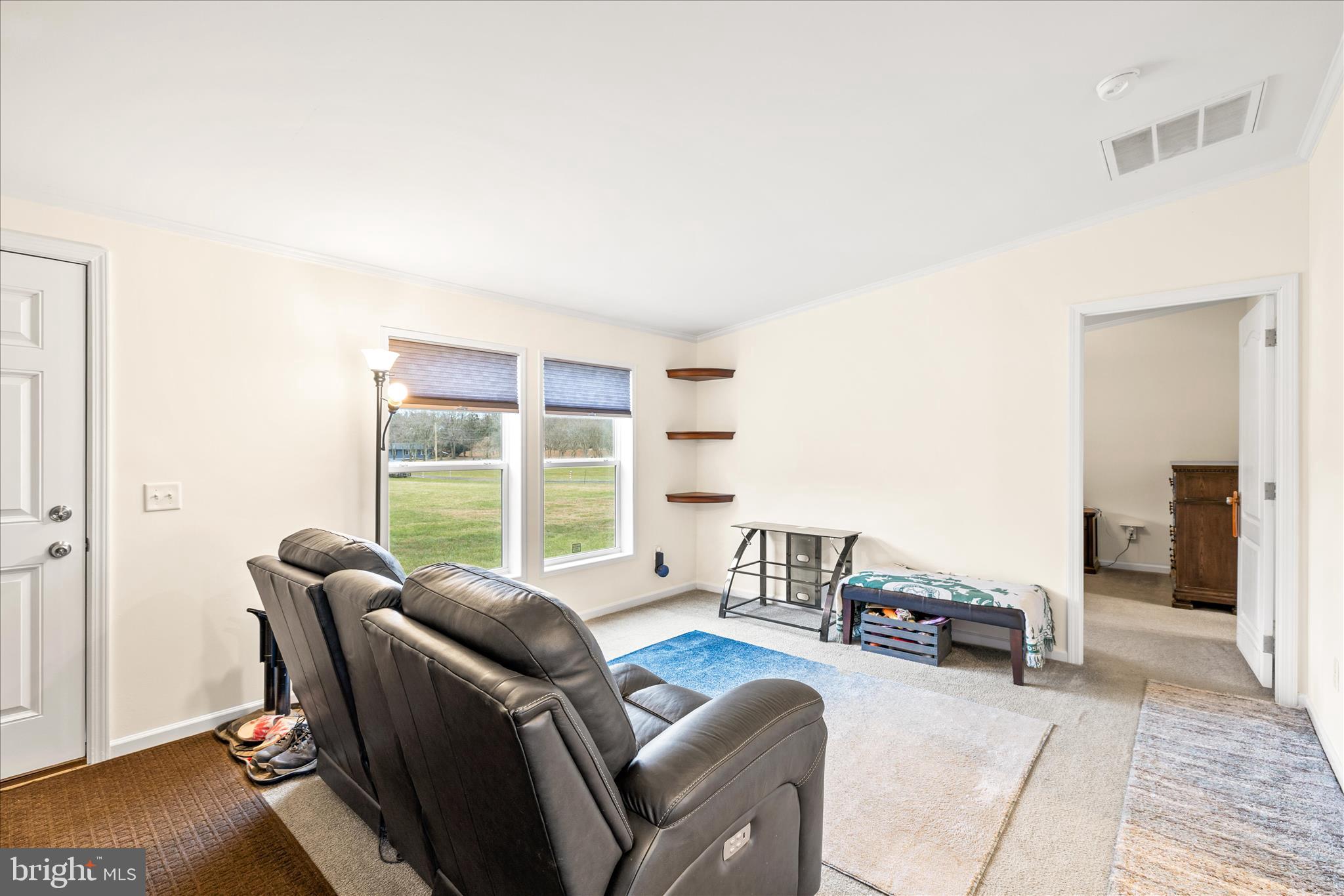 679 Oak Hill School Road Townsend, DE 19734 - Photo 5 of 50 a living room with furniture a large window and a wooden floor