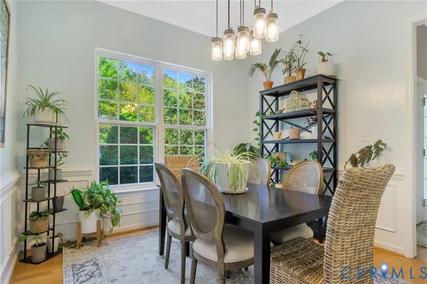 a view of a dining room with furniture wooden floor and a chandelier