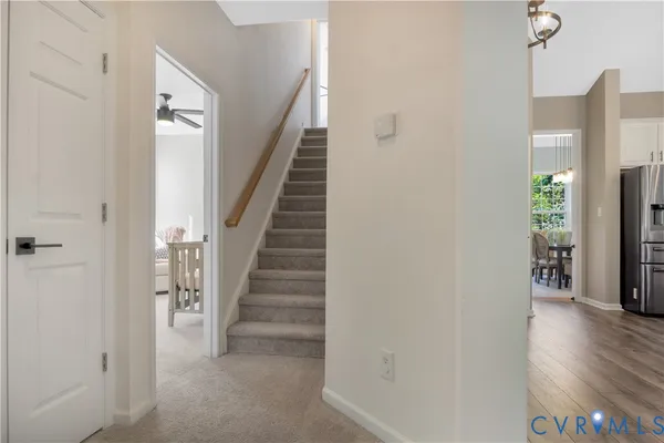 a view of a hallway with wooden floor and staircase