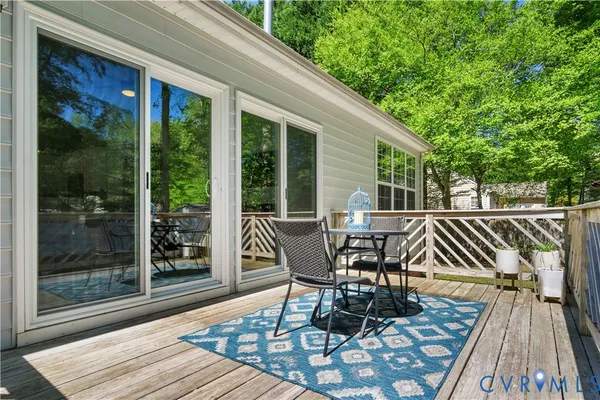 a view of a patio with table and chairs and wooden floor