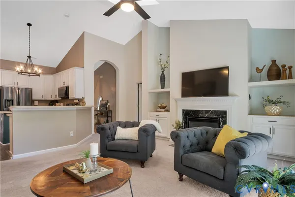 a living room with furniture and a fireplace